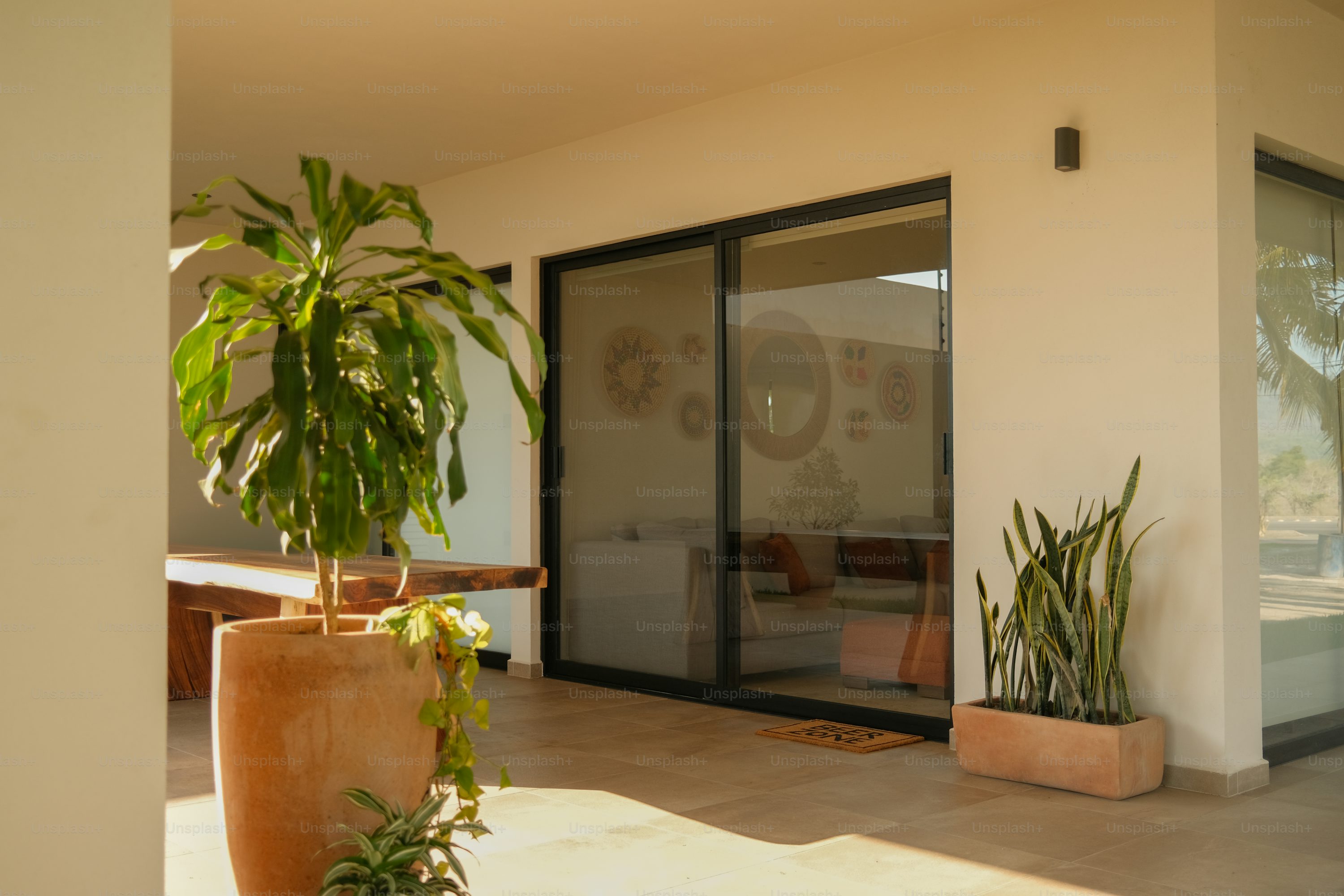 Professional sliding door installation with elegant entrance and plants